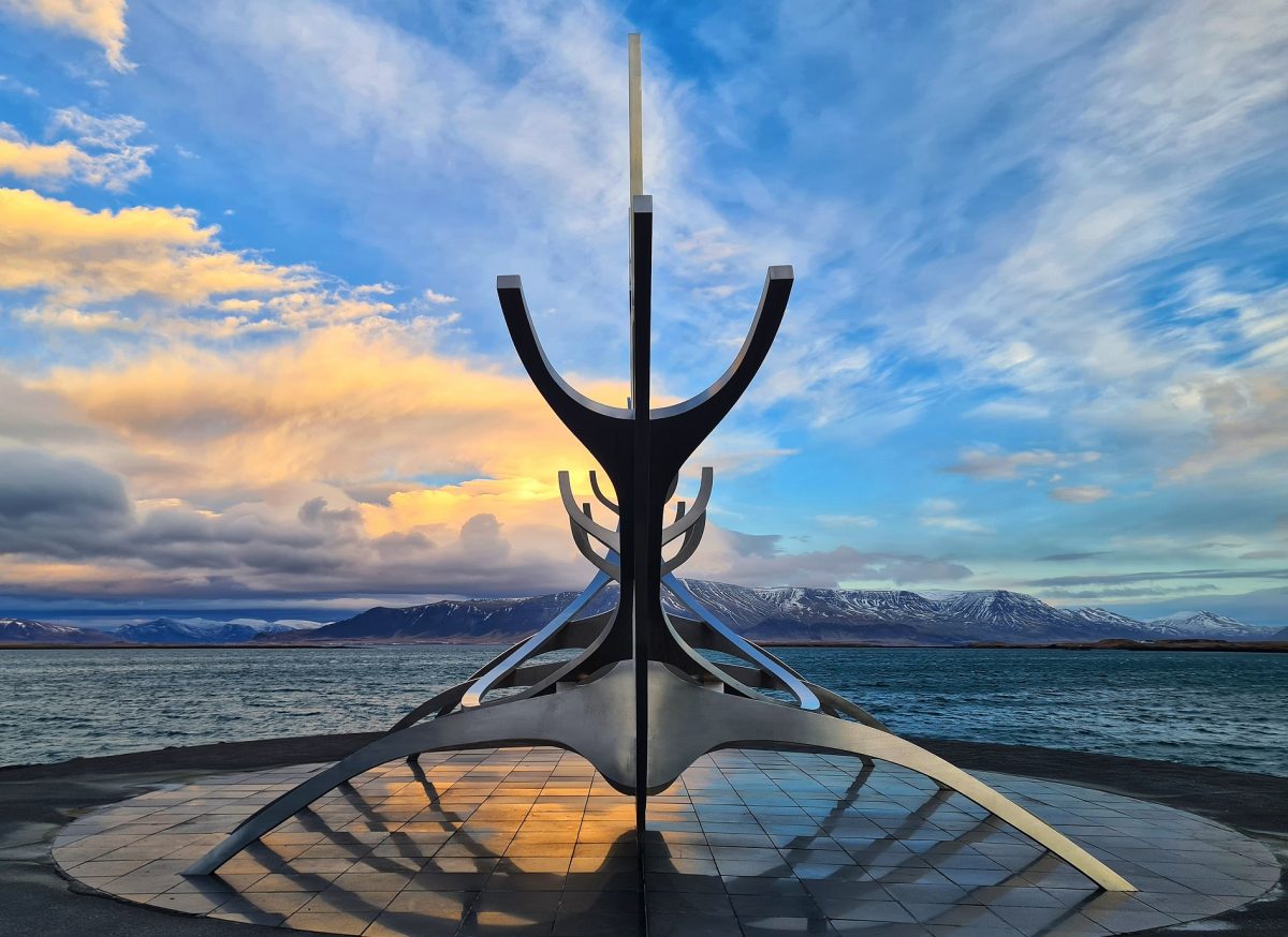 Sculpture of a viking ship at dawn.