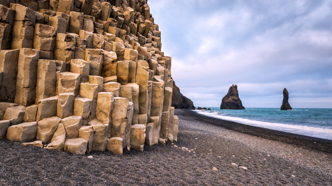 Basalt collumns and rock formations at Black Sand Beach in Iceland.