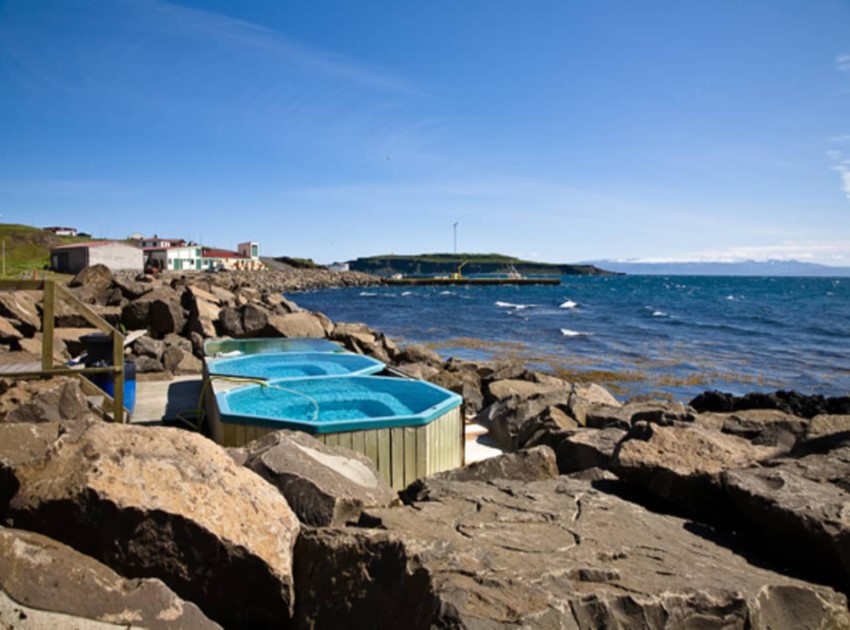 Drangsnes hot tubs with view over the fjords.