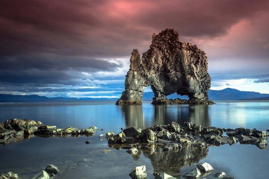 Hvitserkur the Rhino rock in Iceland under a pink sky.