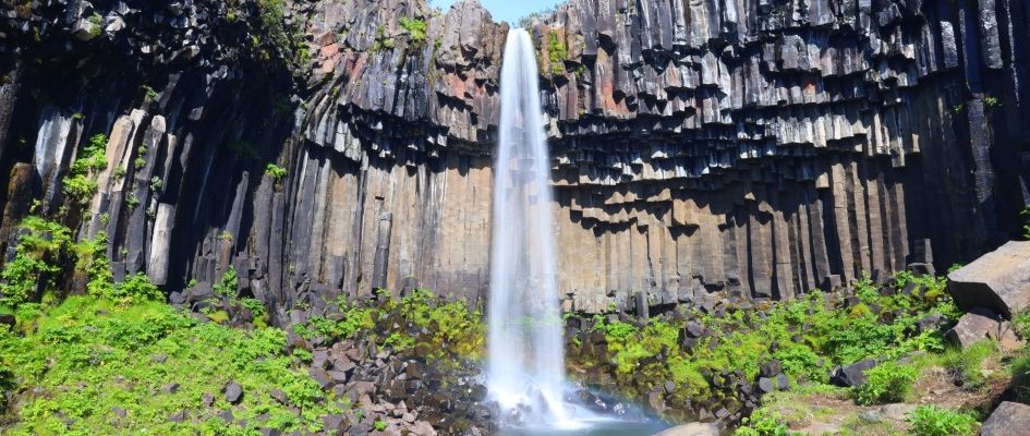Svartifoss waterfall flowing on big basalt walls.