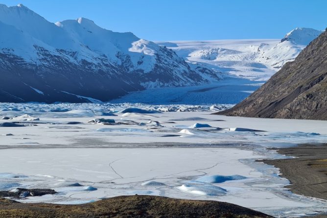 Snowy mountains, giant glacier and a frozen glacier lagoon.