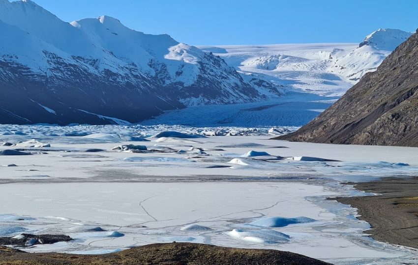 Snowy mountains, giant glacier and a frozen glacier lagoon.