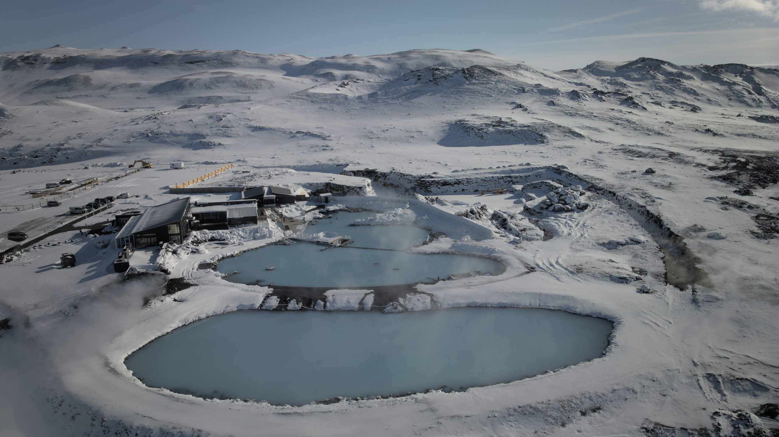 Aerial view of Mývatn Nature Baths covered in snow.