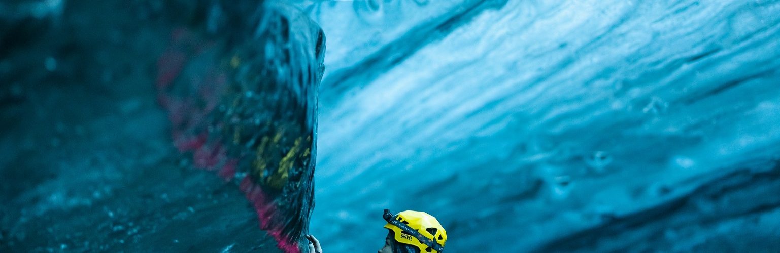 Touching the ice inside a Blue Ice Cave.