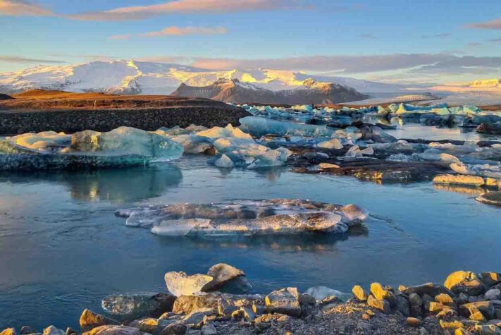 Icebergs at Jokulsarlon Glacier Lagoon shining in the sunset light
